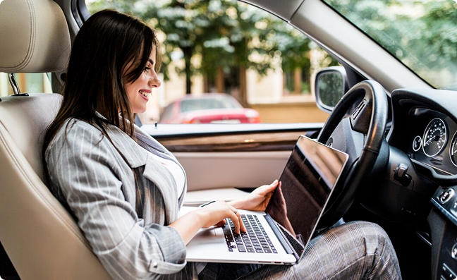 Woman with laptop in car